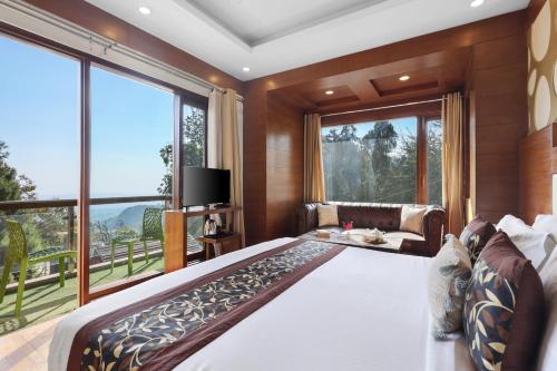 a bedroom with a large bed and a large window at SaffronStays Barlowganj Villa in Mussoorie