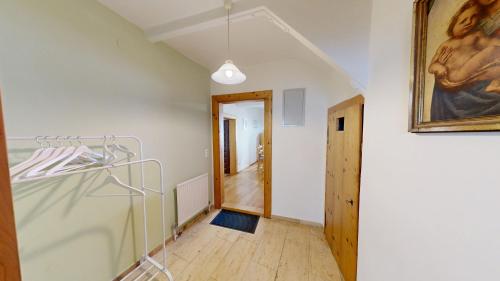 a room with a painting on the wall and a hallway at Apartment in Historic Town House in Gmunden