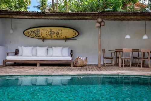 a bed sitting on a patio next to a swimming pool at Vila Santo Rei Trancoso in Trancoso