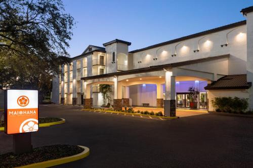 a large building with a sign in front of it at Mai Hana Hotel- Intl Drive, Trademark Collection by Wyndham in Orlando