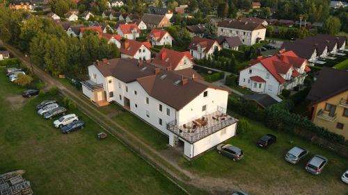 an aerial view of a large house with cars parked at Noce i dnie in Białogóra