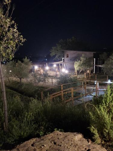 a barn lit up at night with lights at VioVillas Agriturismo Glamping Arezzo in Arezzo
