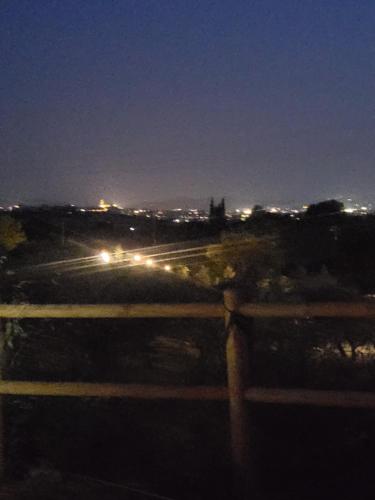 a view of a city at night with lights at VioVillas Agriturismo Glamping Arezzo in Arezzo