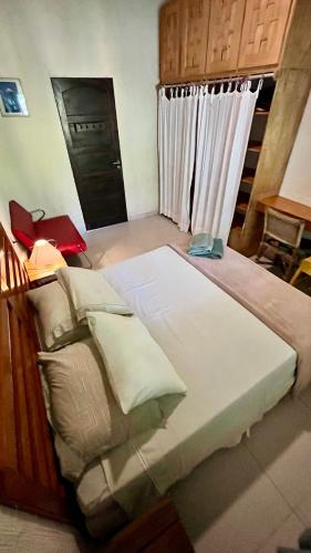 a bedroom with a large bed and a window at Tiny House Noronha in Fernando de Noronha