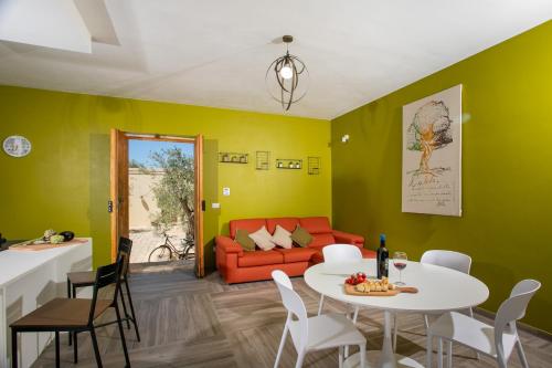 a living room with a table and a couch at Dimora degli Ulivi 10 Emma Villas in Noto