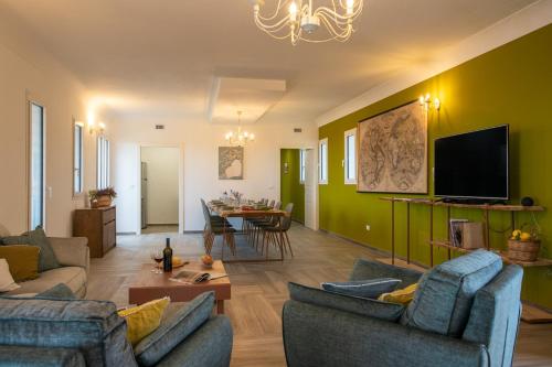 a living room with two couches and a dining room at Dimora degli Ulivi 10 Emma Villas in Noto