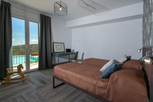 a living room with a couch and a large window at Dimora degli Ulivi 10 Emma Villas in Noto