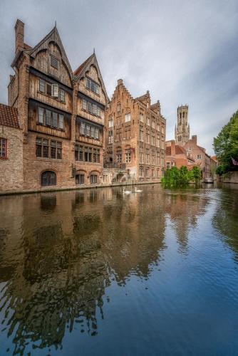 a group of buildings next to a river at B&B Royal Swans in Bruges