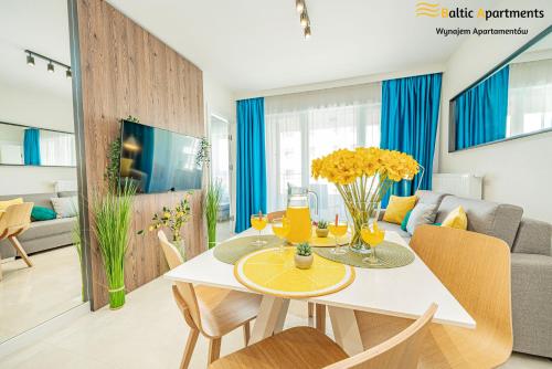 jadalnia i salon ze stołem i krzesłami w obiekcie Baltic Apartments - Sun Towers w Świnoujściu