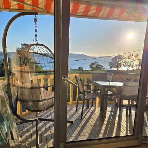 a balcony with a swing and a table and chairs at Perbes Dreams in Perbes