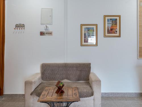 a living room with a couch and a table at Thamosa Stays in Jaipur