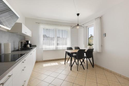 a kitchen and dining room with a table and chairs at Bubach in Laubach