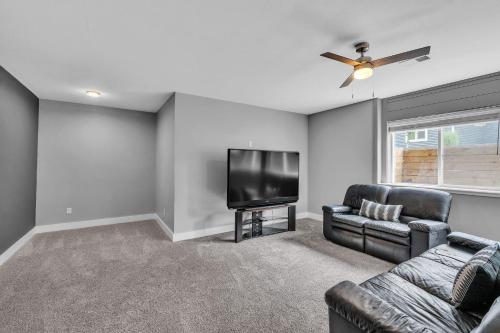 a living room with a couch and a flat screen tv at Pet-Friendly Getaway with Golf & Private Patio Retreat home in South Bend