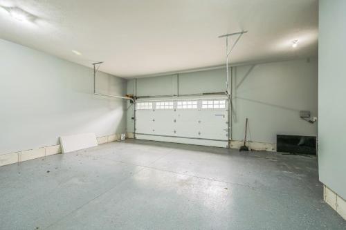 an empty garage with white walls and white garage doors at Pet-Friendly Getaway with Golf & Private Patio Retreat home in South Bend