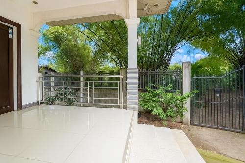 an empty patio with a gate and a fence at Hanella's Place in Bacong