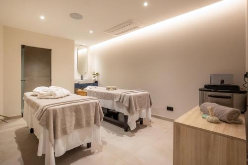 a room with two beds with towels on them at AP Sines - Costa Alentejana in Sines