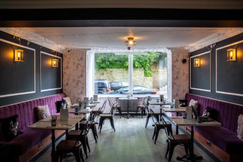 a dining room with tables and chairs and a window at The Psalter in Sheffield