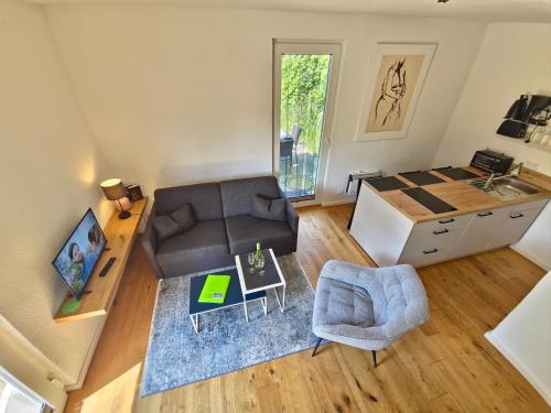 a living room with a couch and a table at Fischstübchen Neeberg Fewo 1 - Hase und Fuchs in Krummin