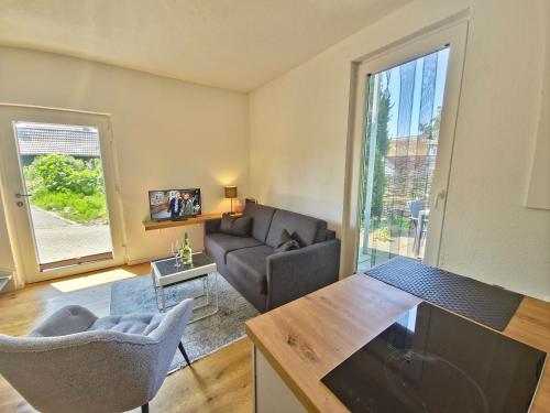 a living room with a couch and a table at Fischstübchen Neeberg Fewo 1 - Hase und Fuchs in Krummin