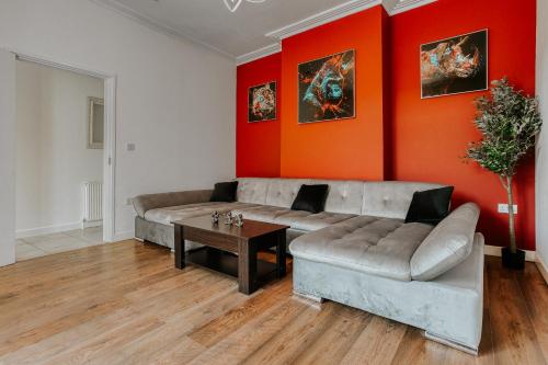 a living room with a couch and a table at Open Mind Property - 4 Bedroom House with Hot Tub in Weston-super-Mare