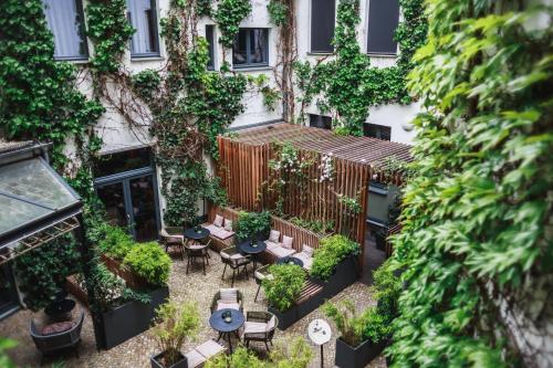 an internal courtyard of a building with tables and chairs at The Circus Hotel in Berlin