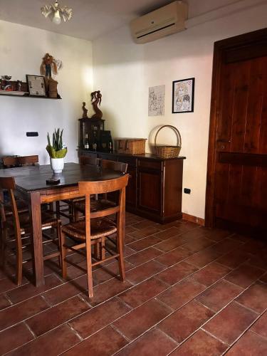 a dining room with a wooden table and chairs at villa Cycas in Maratea