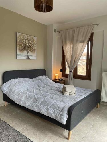 a large bed in a bedroom with a window at Niki's Paradise View in Taxiarchis
