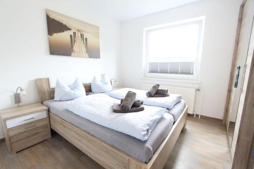 a bedroom with two beds and a window at Inselschatz in Langeoog