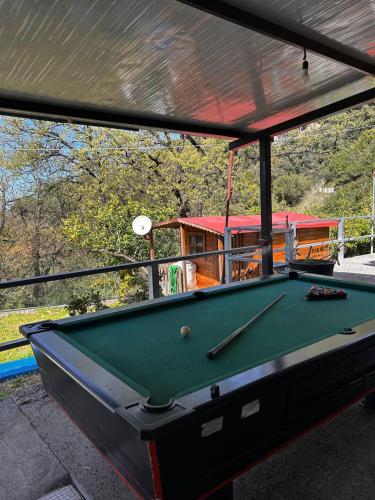 a pool table in front of a boat at villa Cycas in Maratea