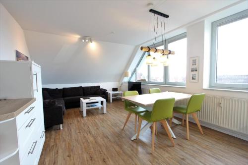 a kitchen and living room with a table and chairs at Insel Sehnsucht in Langeoog