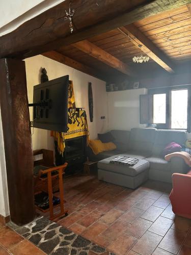 a living room with a couch and a tv at villa Cycas in Maratea