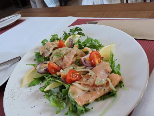 a plate of salad with meat and vegetables on a table at GOŚCINIEC NAD NARWIĄ - Airport Modlin in Kikoły
