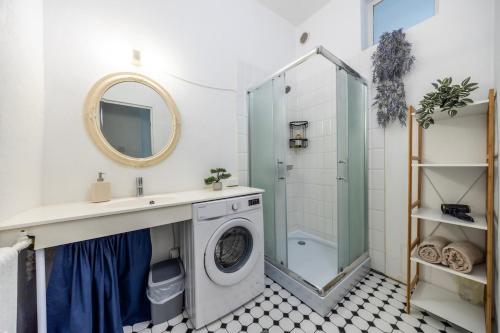 a bathroom with a washing machine and a shower at City center, High ceilings, 75m2 2BR Free parking in Tallinn