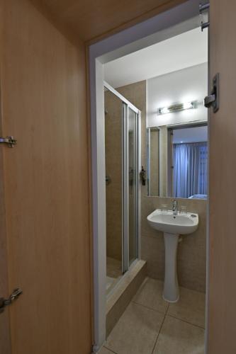 a bathroom with a sink and a shower at Fountains Hotel in Cape Town