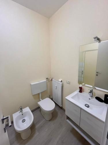 a bathroom with a toilet and a sink and a mirror at La Plata in Desenzano del Garda