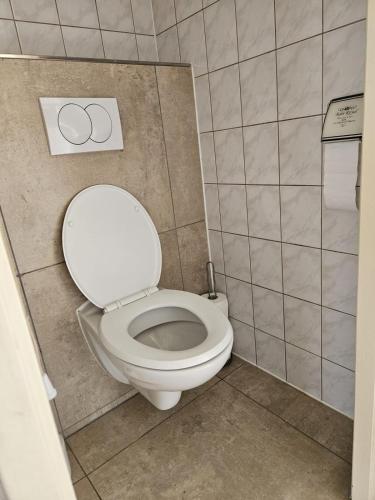 a bathroom with a white toilet in a stall at Parel in Makkum in Makkum