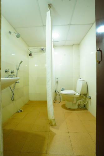 a bathroom with a shower and a toilet in it at Hotel Golden Anchor ,Paradeep in Parādīp Garh