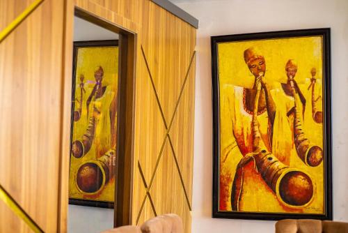 a mirror with a painting of a man holding a drum at Homegate Resort in Araromi