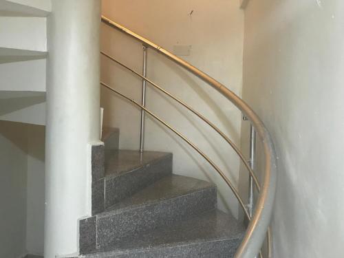 a spiral staircase with a metal railing at Homegate Resort in Araromi