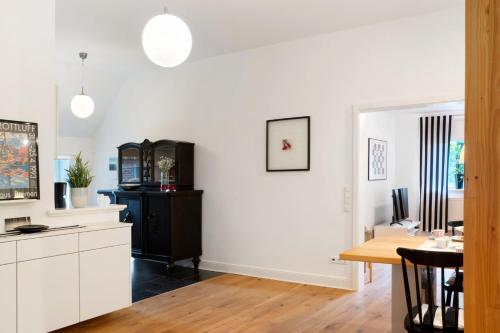 a kitchen with a table and a dining room at Ferienhaus Neudorf in Varel