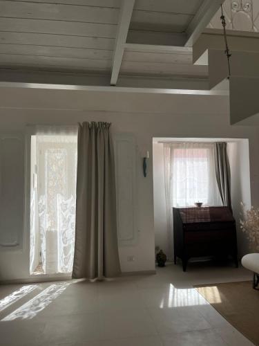 a living room with a piano and a window at Casa Stella Marina in Ponza