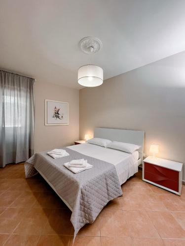a bedroom with a bed and two tables with towels on it at Al Giardino del Pepe in Lanciano