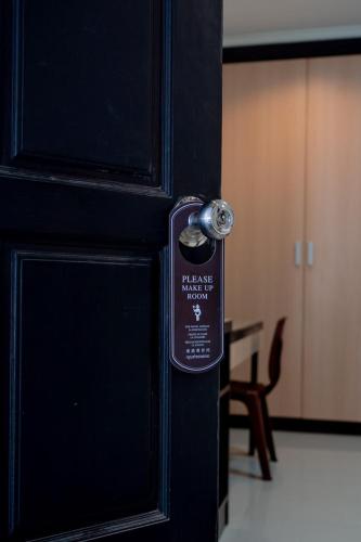 a black door with a door knob on it at JT Place Buriram in Buriram