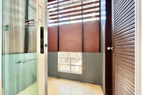 a door to a room with a window at JT Place Buriram in Buriram