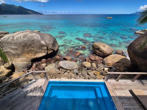 a swimming pool with a view of the ocean at Marquise & Infinity villas in Glacis