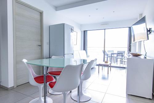 a kitchen and dining room with a glass table and chairs at U Scaldasoli in Propriano