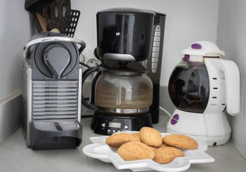 a counter with a blender and a plate of cookies at U Scaldasoli in Propriano