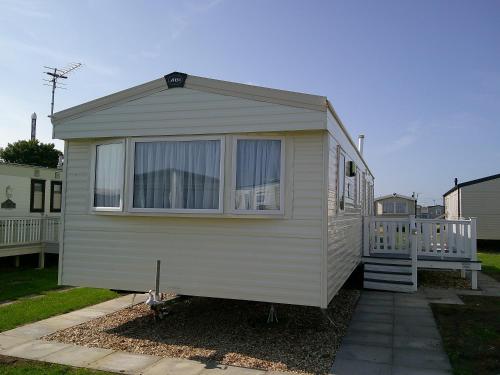 a tiny house is parked in a yard at Kingfisher New Horizon Firs 8 Berth Blow Heated in Ingoldmells