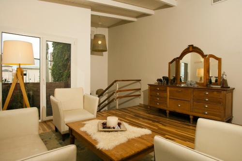 a living room with a dresser and a mirror at La Posada De Madryn in Puerto Madryn