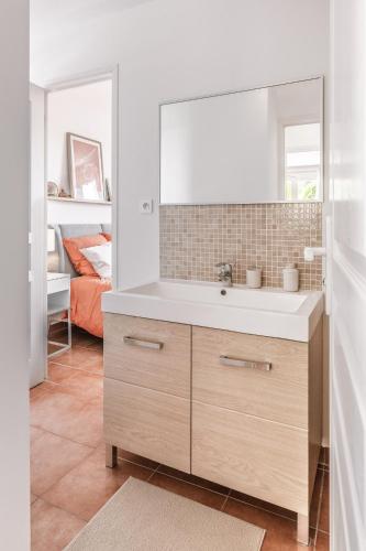 une salle de bain avec un lavabo, un miroir et un lit dans l'établissement SOLEIA - Vue Mer, Piscine & Jardin privé, Parking, à Roquebrune-sur Argens
